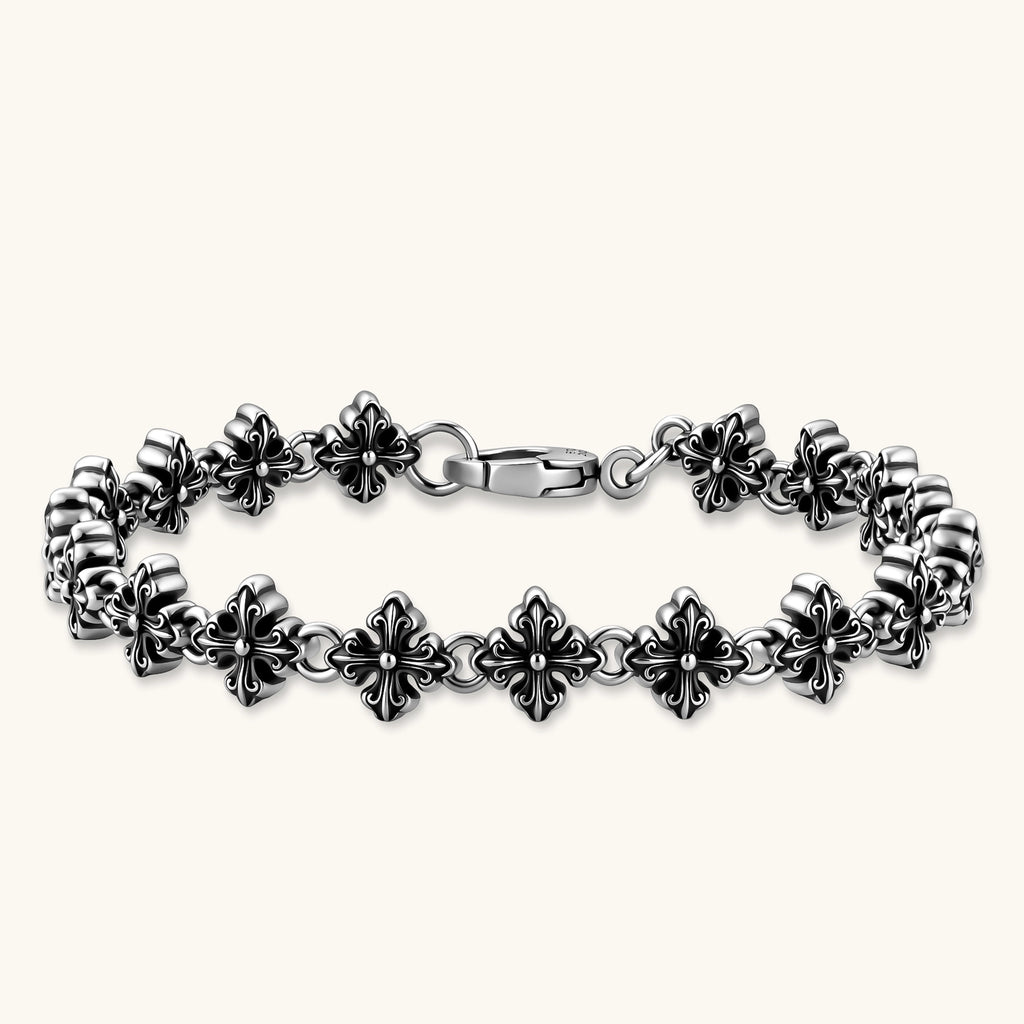 Oxidized 925 sterling silver bracelet with fleur-de-lis cross links and lobster clasp, 8.2mm wide on white background.