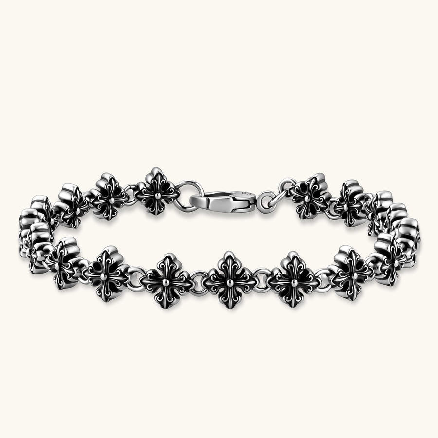 Oxidized 925 sterling silver bracelet with fleur-de-lis cross links and lobster clasp, 8.2mm wide on white background.