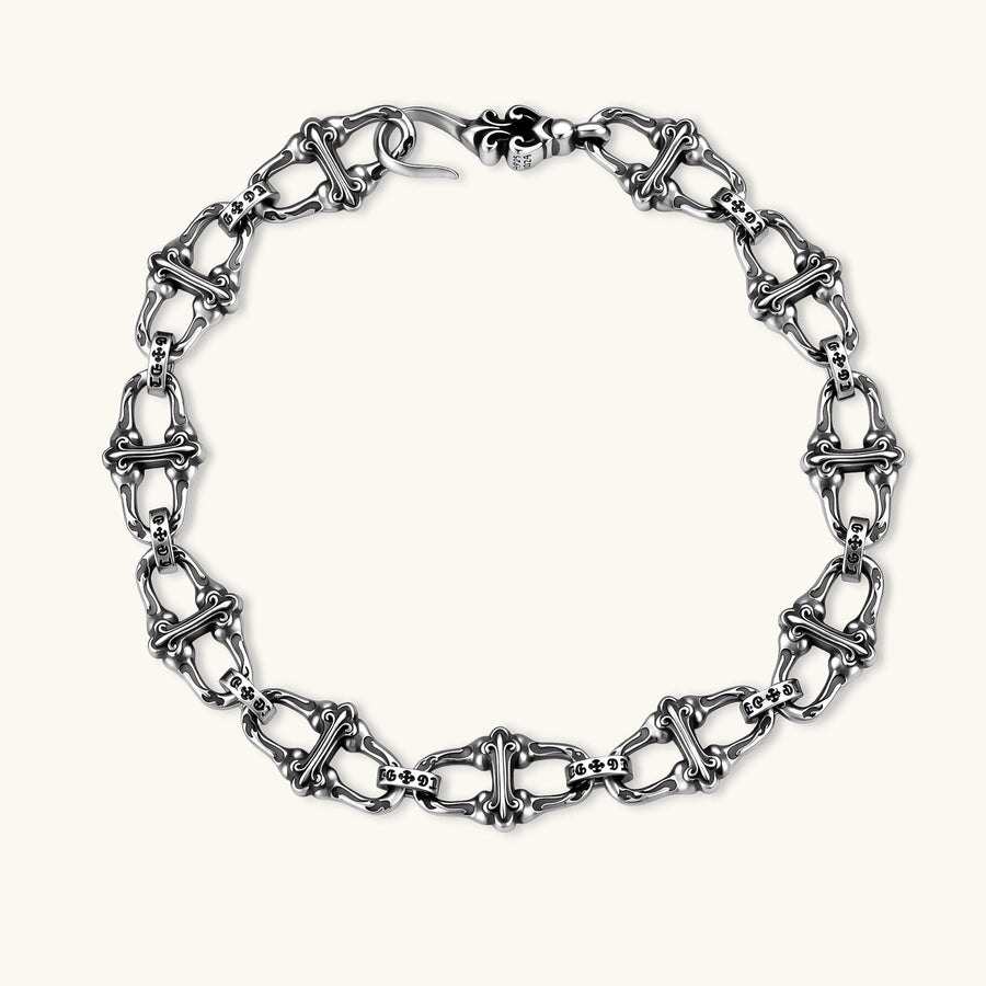 Sterling silver link bracelet with fleur-de-lis cross motifs, oxidized detailing, and hook clasp, 200mm length.