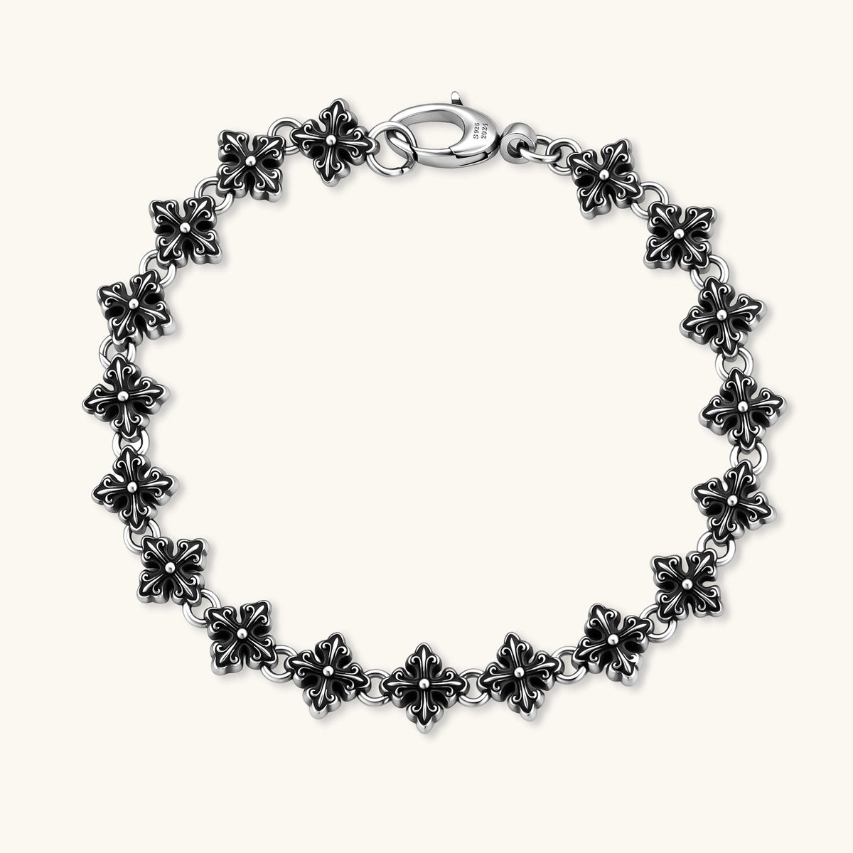 Oxidized 925 sterling silver bracelet with fleur-de-lis cross links and lobster clasp, 8.2mm wide on white background.