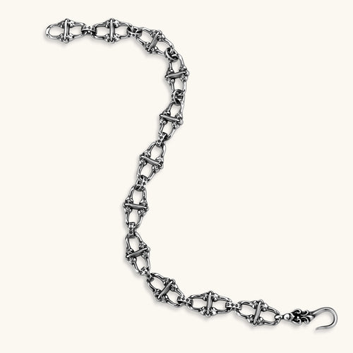 Sterling silver link bracelet with fleur-de-lis cross motifs, oxidized detailing, and hook clasp, 200mm length.